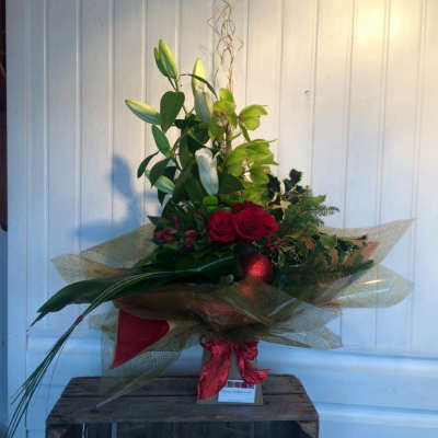 Crimson and Cream - Beautiful orchids, red roses, lilies, holly and seasonal greens