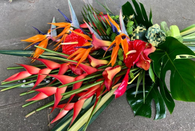 Tropical Flat Hand tie - Stunning tropical stems in reds and oranges hand-tied with lush dark green foliage.

Each bouquet is designed and created by the talented florists at Flowers of Kidderminster. Professional, qualified, local florists, Emma and her team add a touch of pizazz and style to every bouquet. Every arrangement is put together by hand, from scratch, from the wide selection of beautiful fresh flowers here in our shop on Lisle Avenue.

Almost what you're after? We can tailor any bouquet to your needs and budget. Want to incorporate their favourite colours? Do you want to adapt the style to your needs and budget? All colours, styles and budgets can all be catered for.

All flowers are subject to availability. Substitutes may be used but your bouquet will always look beautiful!

This item is available for delivery by Flowers of Kidderminster in Kidderminster and surrounding areas .