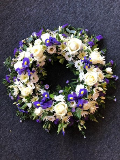 Traditional wreath - Funeral Tributes which reflect the personality and the life of the person sadly departed are created with care and attention by our team of qualified, professional and local florists.

This traditional wreath, can be ordered in different sizes; 12", 14", 16", 18" or 20" and is a made up in the florists selection of purple, cream and white stems. (For 14" and 18" please call the shop)

Please state in your order notes if you would like different colours from those shown in the picture.

Each tribute is designed and created by professional, qualified, local florists, Emma and her team. The talented florists at Flowers of Kidderminster add a touch of style to every bouquet, which is put together by hand, from scratch.

Almost what you're after? We tailor all funeral tributes to your specific requirements. We can incorporate their favourite colours or create a style that reflects their personality. Come in and talk to us about what you would like and we will create it for you.

All flowers are subject to availability. Substitutes may be used but your tribute will always look beautiful!

Funeral Tributes can be delivered on the day to a location of your choice.