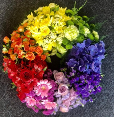 Rainbow Wreath - Funeral Tributes which reflect the personality and the life of the person sadly departed are created with care and attention by our team of qualified, professional and local florists.

Honour them with this Rainbow Wreath made up in the florists selection of colours from throughout the rainbow.

Each tribute is designed and created by professional, qualified, local florists, Emma and her team. At this difficult time, Emma and her team are here to help make choosing and ordering funeral flowers and sympathy tributes a little easier.

Almost what you're after? We tailor all funeral tributes to your specific requirements. We can incorporate their favourite colours or create a style that reflects their personality. Come in and talk to us about what you would like and we will create it for you.

All flowers are subject to availability. Substitutes may be used but your tribute will always look beautiful!

Funeral Tributes can be delivered on the day to a location of your choice.