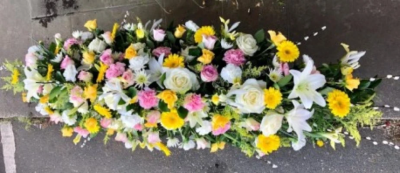Lemon and Pink Coffin Spray - This all lemon and pink, double-ended coffin spray is made up in the florists' selection of stems including Roses, Lilies and Carnations against green foliage and is available in 3 different lengths; 4ft, 5ft or 6ft.

Funeral Tributes which reflect the personality and the life of the person sadly departed are created with care and attention by our team of qualified, professional and local florists.

Express condolences and pay tribute with this spray, expertly prepared by professional, locally based, florists Emma and Laura. At this difficult time, Emma and her team are here to help make choosing and ordering funeral flowers and sympathy tributes a little easier.

All arrangements are created from our collection of fresh flowers at our shop in Lisle Avenue, Kidderminster. 

Almost what you're after? We tailor all funeral tributes to your specific requirements. We can incorporate their favourite colours or create a style that reflects their personality. Come in and talk to us about what you would like and we will create it for you.

All flowers are subject to availability. Substitutes may be used but your tribute will always look beautiful!

Funeral Tributes can be delivered on the day to a location of your choice.