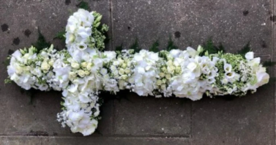 White Cross Tribute - This 3ft White Cross tribute is made from florist selected mixed white blooms including hydrangea, lisianthus and roses.

Funeral Tributes which reflect the personality and the life of the person sadly departed are created with care and attention by our team of qualified, professional and local florists.

Each tribute is designed and created by professional, qualified, local florists, Emma and her team. At this difficult time, we are here to help make choosing and ordering funeral flowers and sympathy tributes a little easier.

Almost what you're after? We tailor all funeral tributes to your specific requirements. We can incorporate their favourite colours or create a style that reflects their personality. Come in and talk to us about what you would like and we will create it for you.

All flowers are subject to availability. Substitutes may be used but your tribute will always look beautiful!

Funeral Tributes can be delivered on the day to a location of your choice.