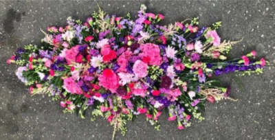 Summer Casket Spray - This summer bloom, double-ended coffin spray is made up in the florists' selection of pink and purple stems alongside delicate foliage and is available in 2 different lengths; 5ft or 6ft.

Funeral Tributes which reflect the personality and the life of the person sadly departed are created with care and attention by our team of qualified, professional and local florists.

Express condolences and pay tribute with this spray, expertly prepared by professional, locally based, florists Emma and Laura. At this difficult time, Emma and her team are here to help make choosing and ordering funeral flowers and sympathy tributes a little easier.

All arrangements are created from our collection of fresh flowers at our shop in Lisle Avenue, Kidderminster. 

Almost what you're after? We tailor all funeral tributes to your specific requirements. We can incorporate their favourite colours or create a style that reflects their personality. Come in and talk to us about what you would like and we will create it for you.

All flowers are subject to availability. Substitutes may be used but your tribute will always look beautiful!

Funeral Tributes can be delivered on the day to a location of your choice.